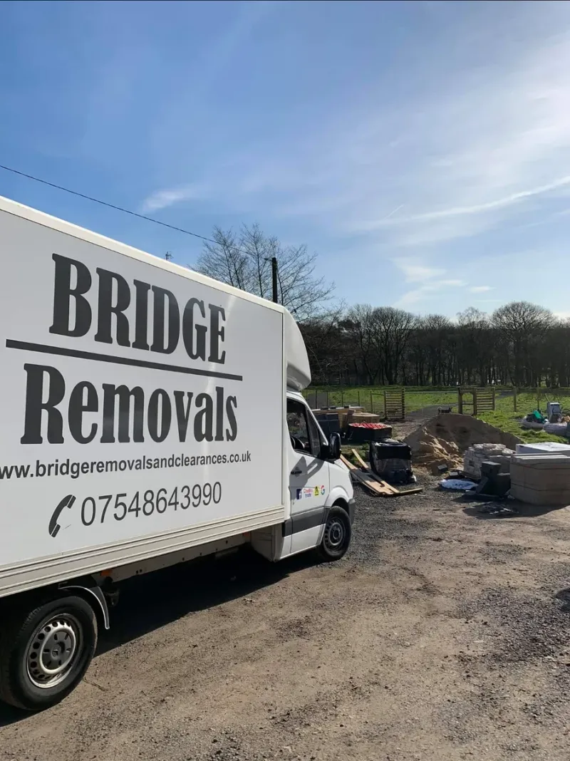 Bridge Removals van at a clearance site with bare winter trees behind, ready for a garden clearance.