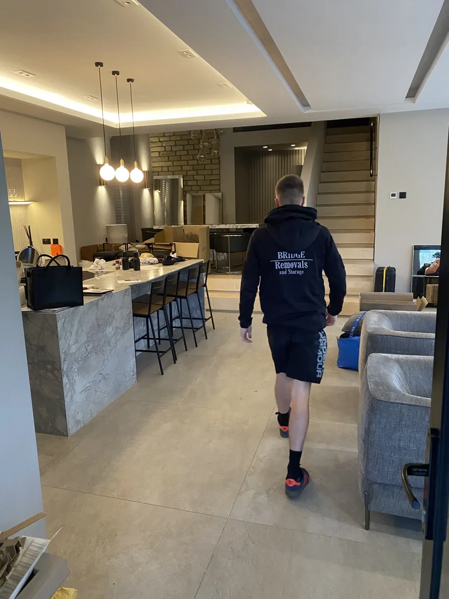 House Removals in an Edenfield Marble Kitchen Bridge Removals crew member walks through a marble kitchen island during a house removals job in Edenfield.