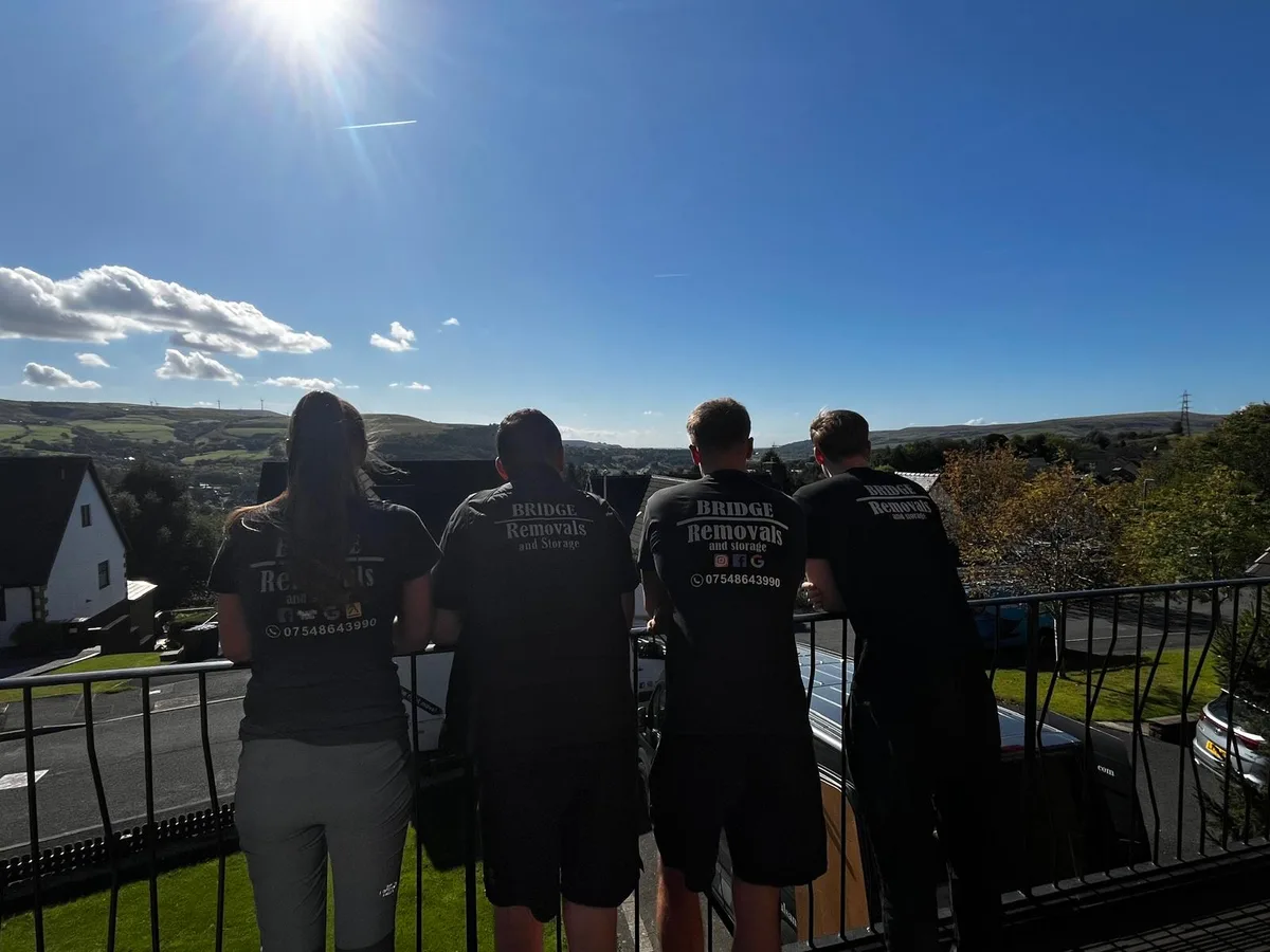 Bridge Removals crew taking in a valley view from a railing between jobs