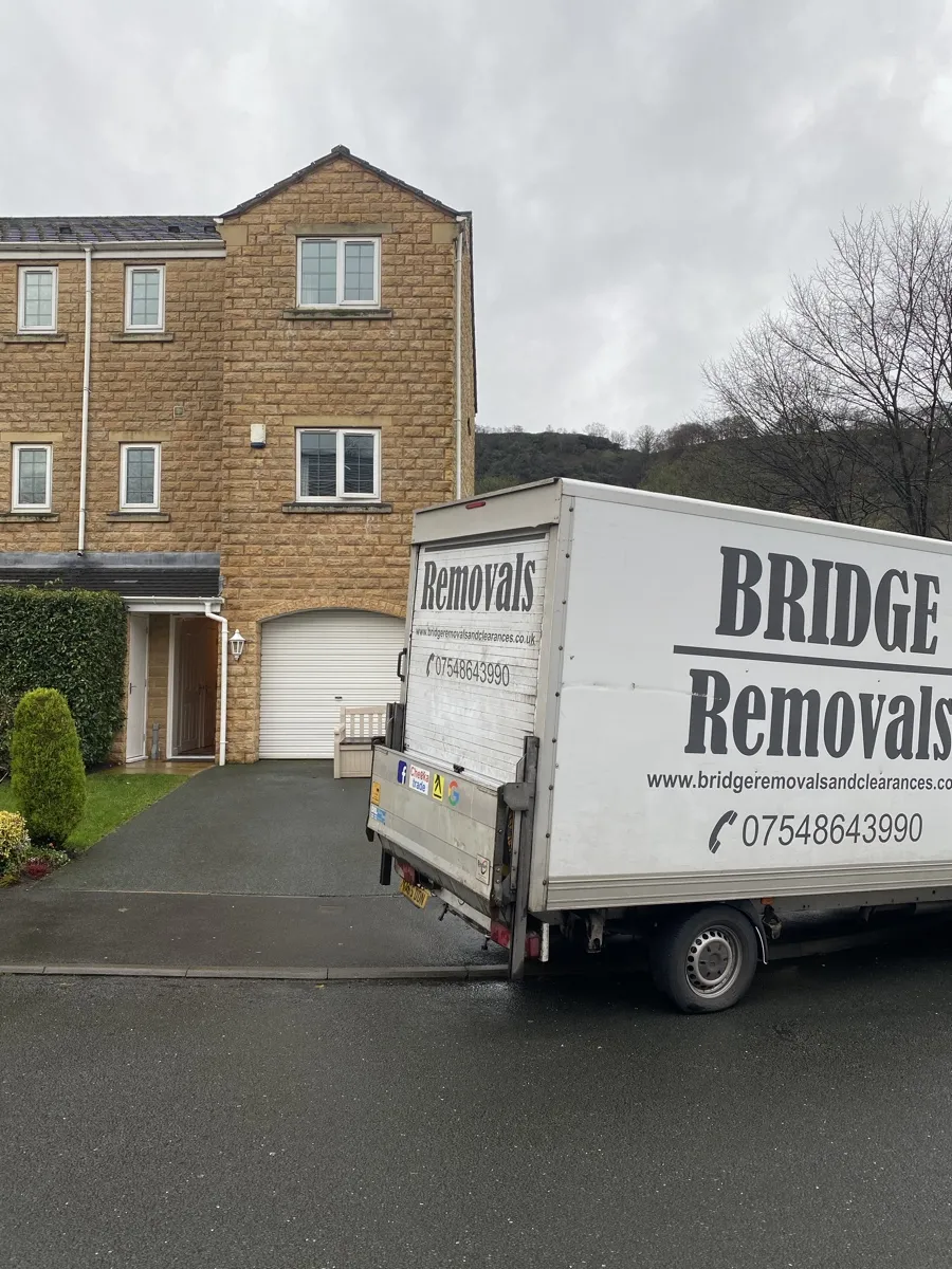 House Removals with the Tail Lift Down in Todmorden Bridge Removals van with its tail lift down outside a stone terraced house in Todmorden, on a house removals job.
