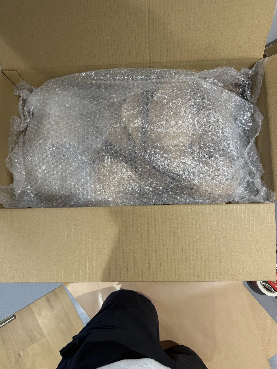 Packing Service with Bubble-Wrapped Care Bridge Removals wraps a fragile item in bubble wrap and boxes it up as part of a packing service.