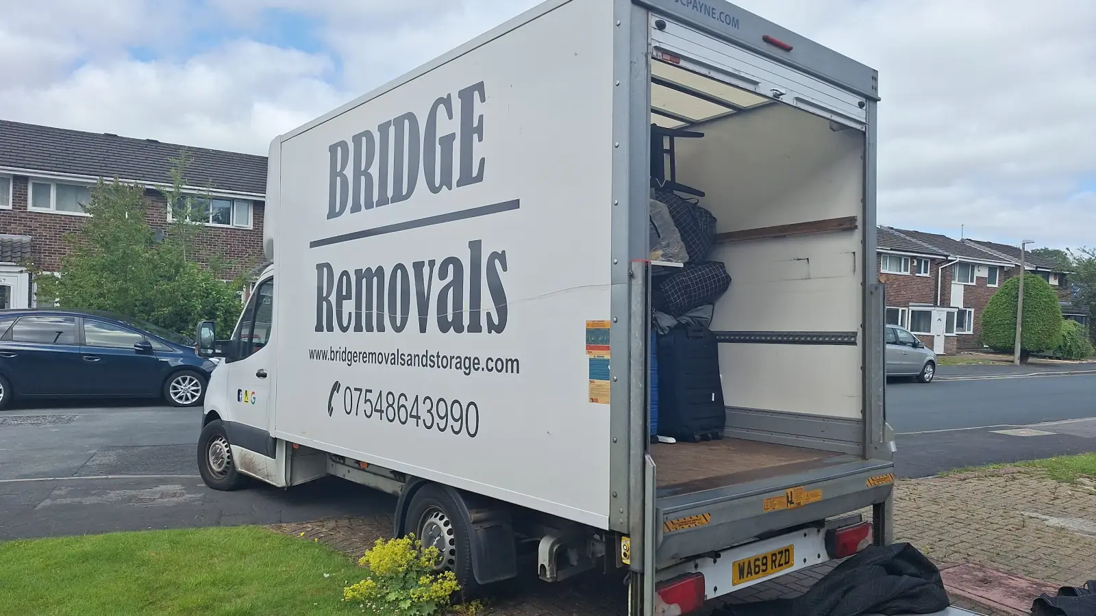 Customer-submitted photo showing a Bridge Removals van with its tail lift down and furniture loaded