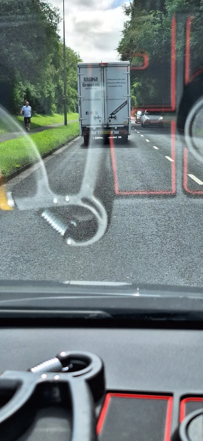 Customer-submitted photo showing a Bridge Removals van on a tree-lined road