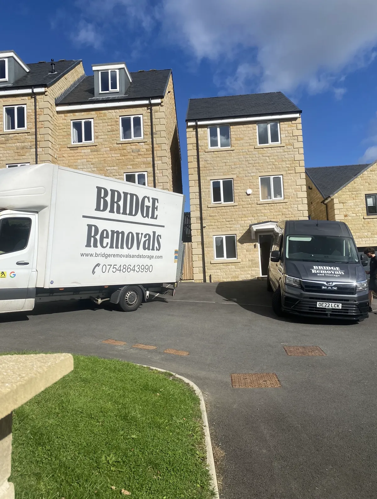 Sunny New Build Townhouse Removal Bridge Removals box van and panel van outside new-build stone townhouses on a sunny house removals job.