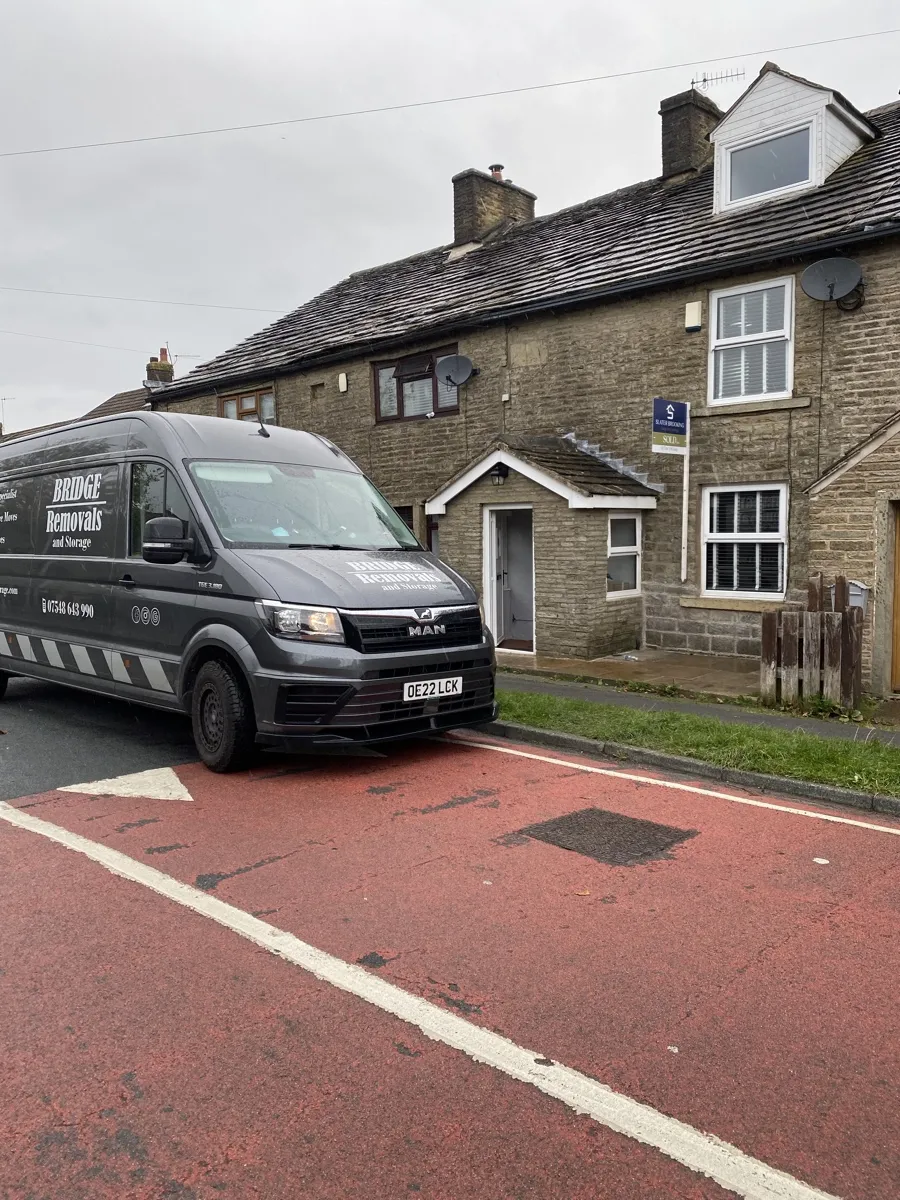 Helmshore Terrace Cottage Removal Bridge Removals van parked on the red road through Helmshore's stone cottages during a house removals job.