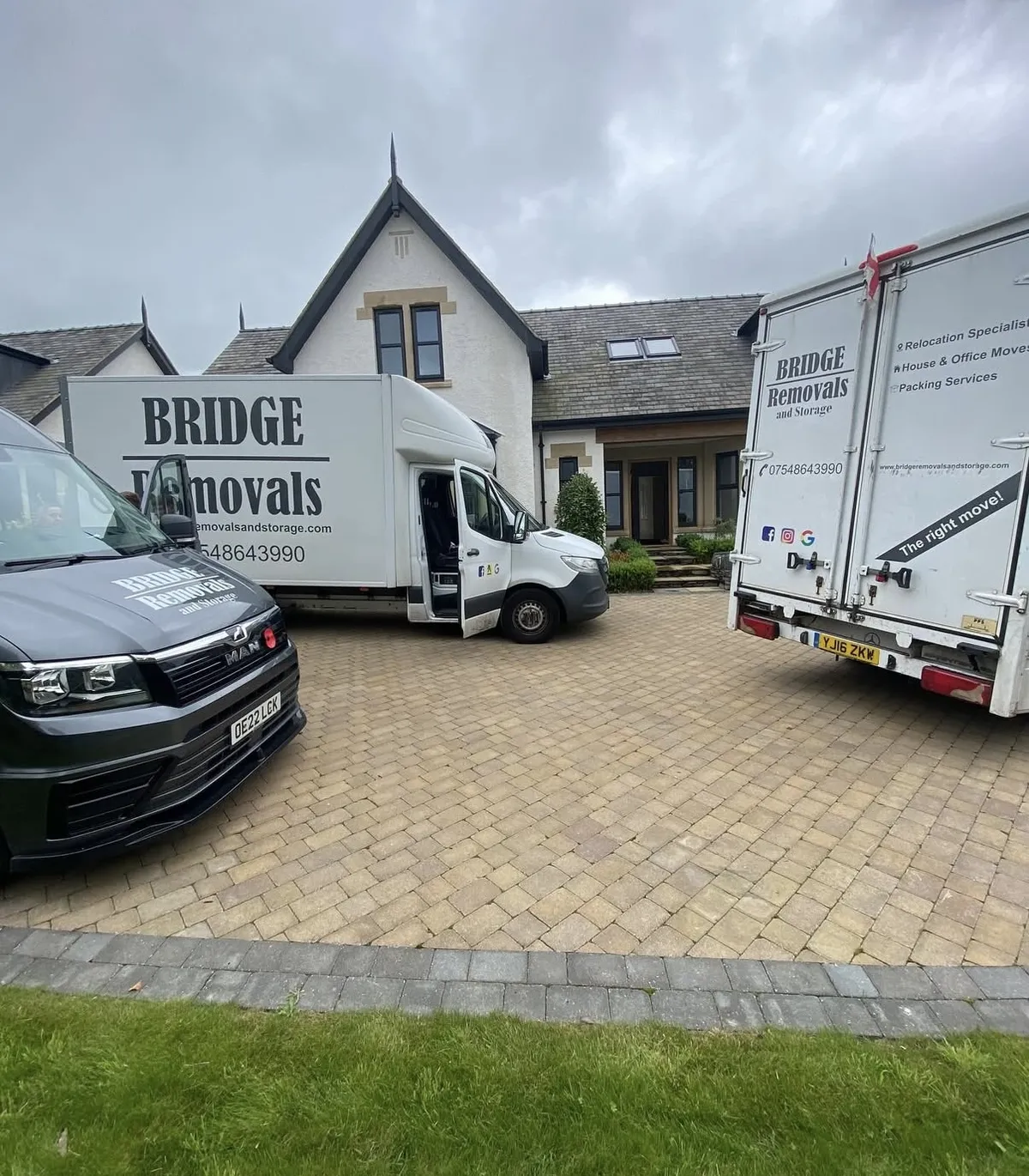Three Bridge Removals vans on a house move at a large white detached house