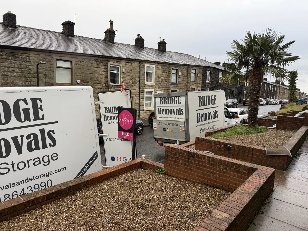 Ramsbottom Terrace Move With Three Vans Three Bridge Removals vans lined up outside stone terraces in Ramsbottom on a house removals job.