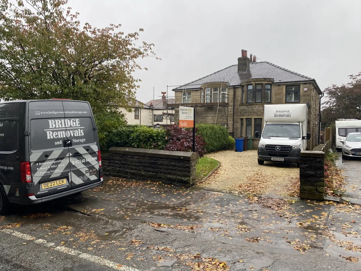 Summerseat Autumn House Move In The Rain Two Bridge Removals vans outside a stone semi in Summerseat on a wet autumn house removals job.