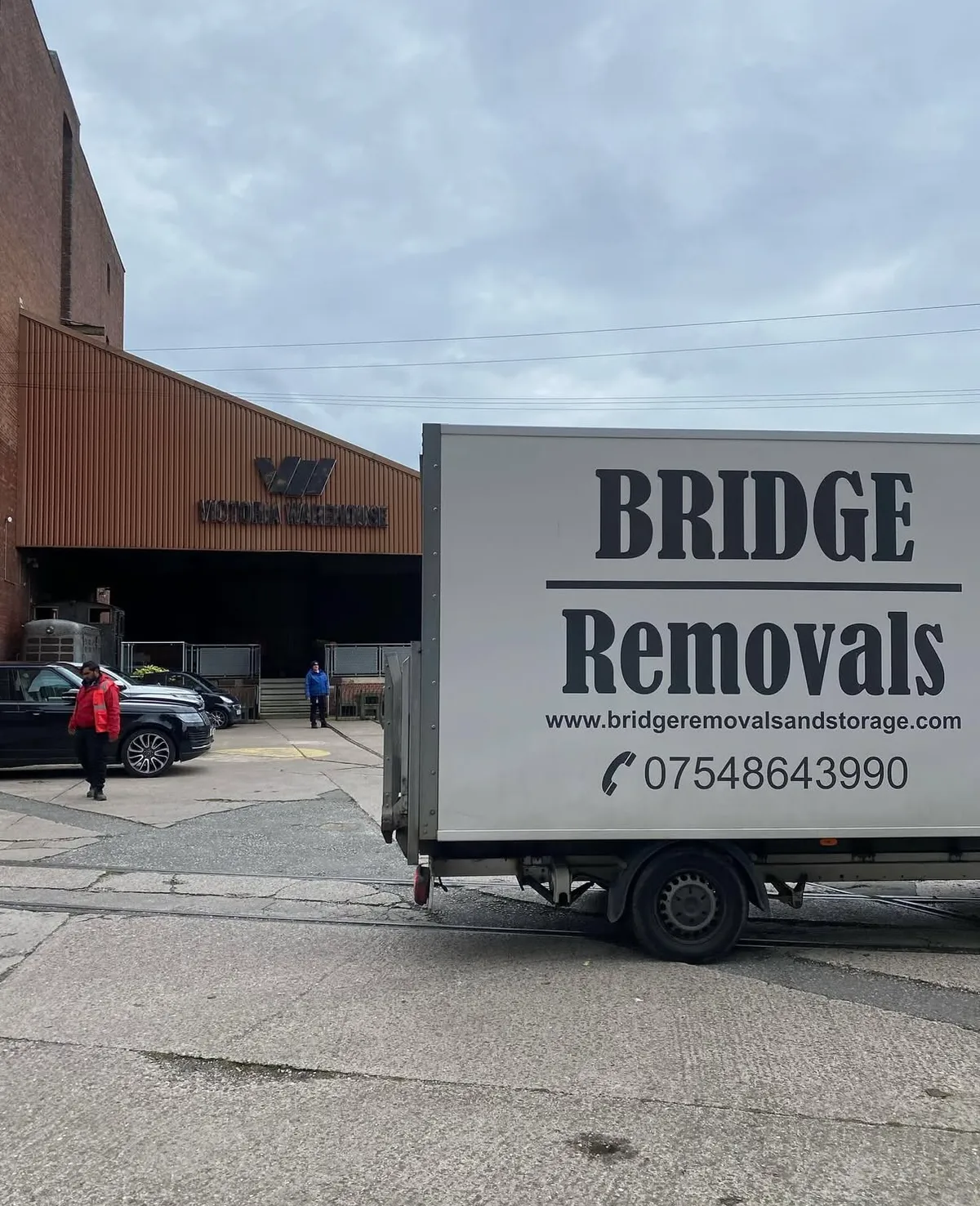Man and Van Loading at a Warehouse Entrance Bridge Removals van parked outside the Victoria Warehouse loading entrance, ready for a single-item job.